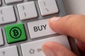 Buy bitcoin concept. Close up keyboard button choice of buying cryptocurrency bitcoin to get profit Royalty Free Stock Photo