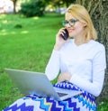Buy clothes online. Girl sit grass with notebook. Woman with laptop in park order item on phone. Girl takes advantage of Royalty Free Stock Photo