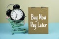 Buy Now Pay Later text message with trolley cart and alarm clock for business and commercial concepts background Royalty Free Stock Photo
