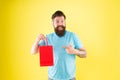 Buy product. Gender differences in purchase decision making. Happy hipster hold paper bag. Bearded man smiling with