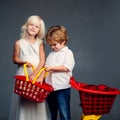 Buy products. Play shop game. Cute buyer customer client hold shopping cart. Girl and boy children shopping. Kids store Royalty Free Stock Photo