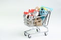 Buy and sell house, property demand and supply on real estate purchasing concept, shopping cart or trolley with full of small cute Royalty Free Stock Photo