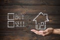 Buy or sell house written on wooden boards.