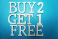 Buy two get one Free Sale Promotion on blue background Royalty Free Stock Photo