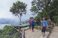 Buyan Lake, Bali - November 25th, 2017: Tourist having fun taking photo at a man made platform with Buyan lake as the background. Royalty Free Stock Photo