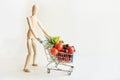 Buyer as dolls with grocery trolley. Full food basket. Concept shopping Royalty Free Stock Photo