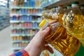 Buyer buys sunflower oil in a grocery store. Royalty Free Stock Photo