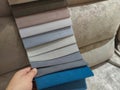 The buyer chooses the color of the fabric for the sofa.Tissue catalog.Fabric color samples
