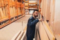 a buyer in a construction hypermarket in the lumber department chooses boards and plywood for repairs Royalty Free Stock Photo