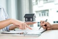 Buyer hand signs contract after Real estate agents explains a business contract, lease, purchase, mortgage, loan, or home