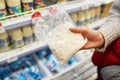 Buyer hands with cottage cheese in the grocery store