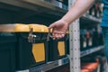 The buyer in the hardware store selects the goods. A man holds a tool box in his hand Royalty Free Stock Photo