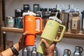 Buyer holds two Stanley tumblers, orange and green Royalty Free Stock Photo