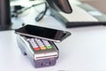 . Buyer, payment through the POS terminal. mobile phone as a bank card. there is toning Royalty Free Stock Photo