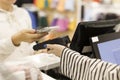 The buyer pays for purchases in the store, puts the smartphone to the terminal.