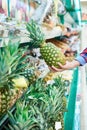 Buyer with pineapple in store