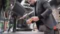 Buyer scans bottle of beer through barcode scanner at self-service checkout ACO in supermarket. Assisted checkout SCO