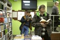 Buyer standing in front of a pile of fiction books buying, bookshop. Kyiv, Ukraine