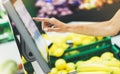 The buyer weighs the yellow bananas and points the fingers on the screen electronic scales, woman shopping healthy food in super Royalty Free Stock Photo