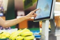 The buyer weighs the yellow bananas and points the fingers on the screen electronic scales, woman shopping healthy food Royalty Free Stock Photo