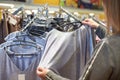 Buyer woman chooses clothes in store