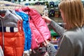 Buyer woman chooses kid jacket clothes in store Royalty Free Stock Photo