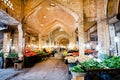 Buyers select fresh fruits and vegetables under the ancient vaults of Eastern Bazaar.