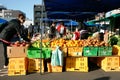 Buyers select fresh vegetables at market.