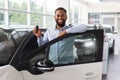 Buying Auto. Black Man With Keys In Hand Standing Near New Car Royalty Free Stock Photo