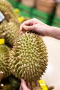 Buying a big piece of Durian from the stall at supermarket.