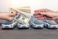 `Buying car ` conception, dollar deal between female hands Royalty Free Stock Photo