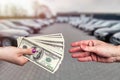 `Buying car` conception, dollar deal between female hands Royalty Free Stock Photo