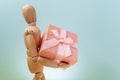 Online shopping, wooden mannequin with gifts. Online valentine, xmas shopping concept. Royalty Free Stock Photo