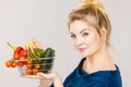 Woman holds shopping basket with vegetables Royalty Free Stock Photo