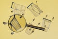 buying goods in a supermarket. shopping carts and a magnifying glass scattered on a yellow background. 3d render