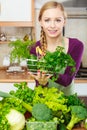 Woman in kitchen having vegetables holding shopping basket Royalty Free Stock Photo