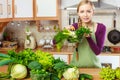 Woman in kitchen having vegetables holding shopping basket Royalty Free Stock Photo