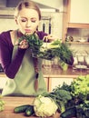 Woman in kitchen having vegetables holding shopping basket Royalty Free Stock Photo