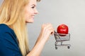 Woman holding shopping cart with apple inside Royalty Free Stock Photo