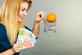 Woman holding shopping cart with orange inside Royalty Free Stock Photo