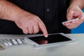 Buying medicine over the Internet, male hands holding pills drug sample and typing order on a laptop keyboard Royalty Free Stock Photo