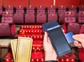Buying movie tickets. Payment by card purchase modern payment blue terminal Royalty Free Stock Photo