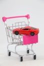 Buying a new car, Car in shopping cart isolated. Royalty Free Stock Photo