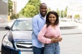 Happy black couple standing near car and hugging Royalty Free Stock Photo