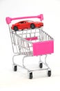 Buying a new car, Car in shopping cart isolated. Royalty Free Stock Photo