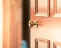 Buying new home, selling your home, inviting people over to your home, door knob, door handle, slightly opened wooden door in old Royalty Free Stock Photo