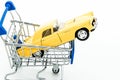 buying new car concept toy car in Shopping Cart roll Royalty Free Stock Photo