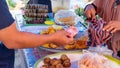 Buying and selling interactions between buyers and sellers of fried cakes at a traditional morning market