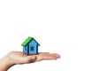 Buying and selling real estate. Mortgage loan. Miniature little house on the palm of the hand on the white background. Rent home. Royalty Free Stock Photo