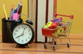 Buying Time collage with shopping trolley on Wooden board backgorund